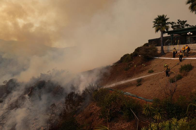 Thousands of firefighting and emergency personnel are involved in response efforts, as multiple wildfires continue to burn across thousands of acres in Southern California.