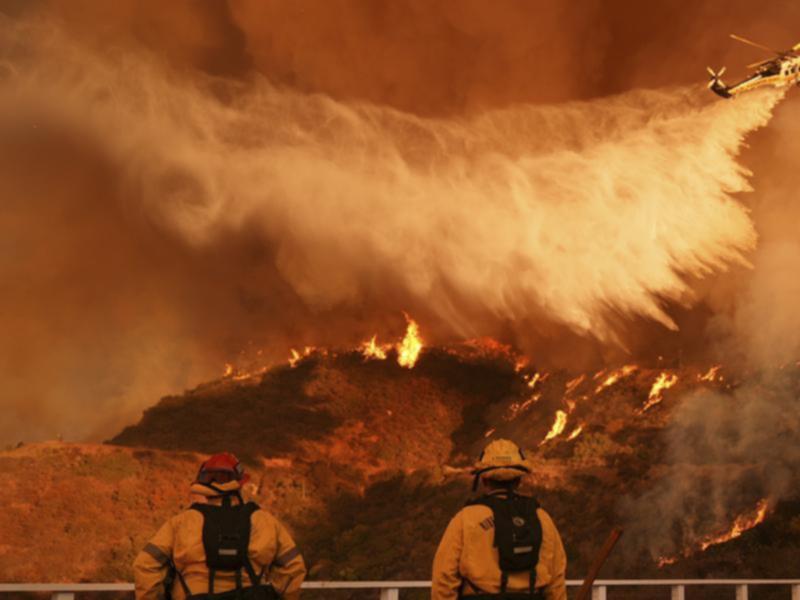 Firefighting aircraft have joined the desperate effort to stop blazes spreading in Los Angeles. (AP PHOTO)