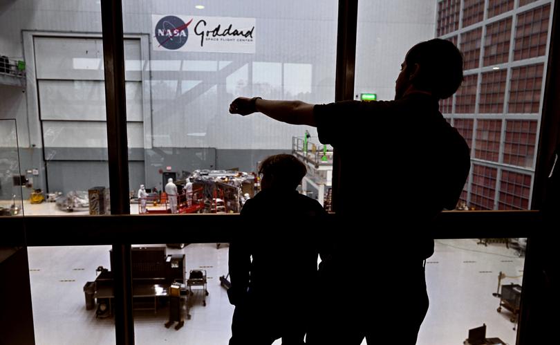 Jane Rigby and Josh Schlieder look out above the assembly area of the Nancy Grace Roman Telescope. 