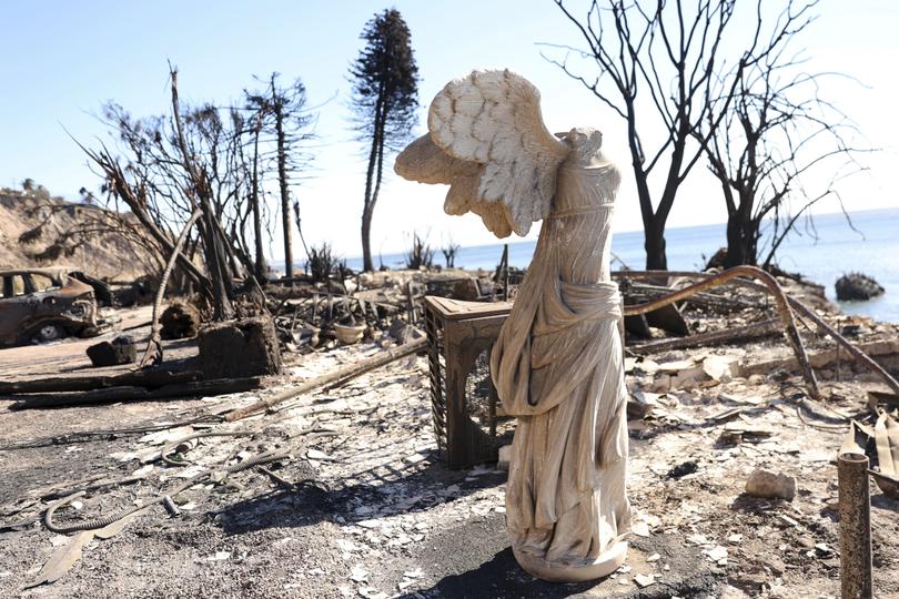 A sculpture is all that remains at a burned home during the aftermath of the Palisades Fire along Pacific Coast Highway in Malibu.