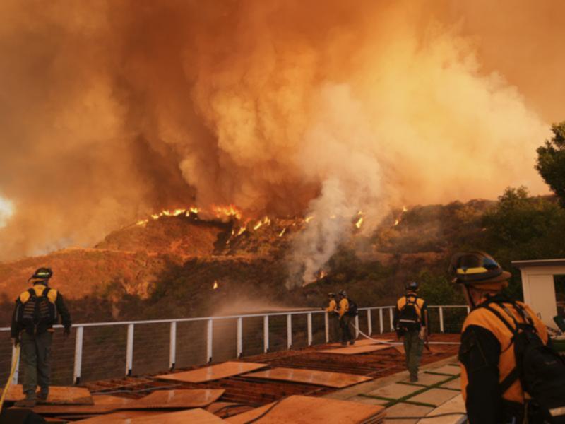 Firefighting aircraft have joined the desperate effort to stop blazes spreading in Los Angeles. (AP PHOTO)