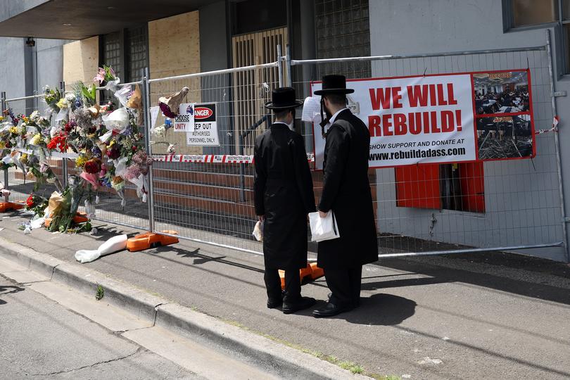 People gather outside the Adass Israel Synagogue after a firebombing in Melbourne, Monday, December 9, 2024. 