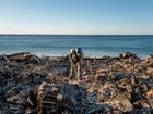 Patrick O'Neal sifts through his home after it was destroyed by the Palisades wildfire on January 13, 2025 in Malibu, California. 