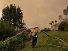 Firefighters are holding the line against LA wildfires that are still raging in extreme winds. 