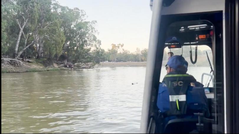 Marine Rescue volunteers search the Murray River after a missing man fell from a boat.