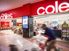 A shopper pushes a trolley outside a Coles supermarket in Sydney.