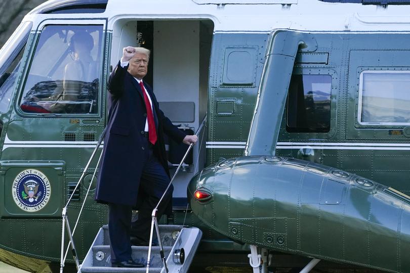 President Donald Trump gestures as he boards Marine One on the South Lawn of the White House, Wednesday, Jan. 20, 2021.