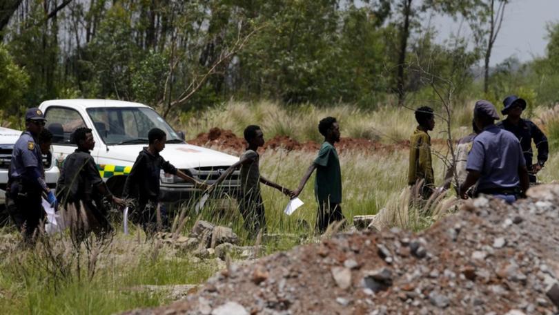 Miners, some of them emaciated and disorientated, have been brought to the surface and arrested.