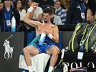 Thanasi Kokkinakis grimaces with his pectoral injury between games during his second-round loss. (James Ross/AAP PHOTOS)