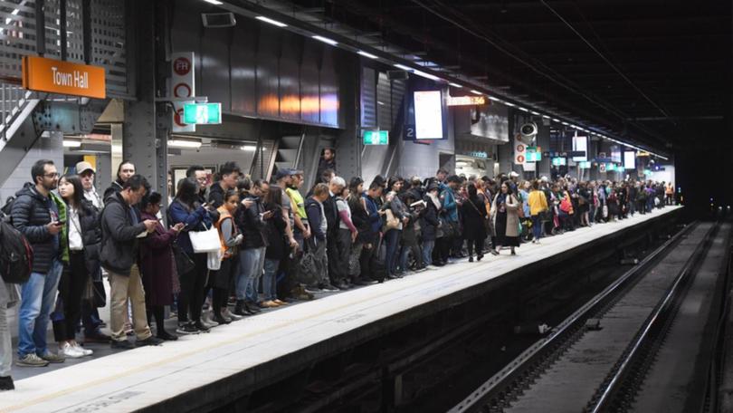 Storms added to rail chaos from industrial action, disrupting NSW commuters for a second day. (Peter Rae/AAP PHOTOS)