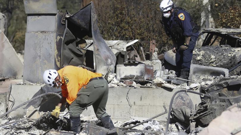 Search and rescue workers dig through the rubble left behind by the Eaton Fire, in Altadena.