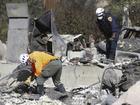 Search and rescue workers dig through the rubble left behind by the Eaton Fire, in Altadena.