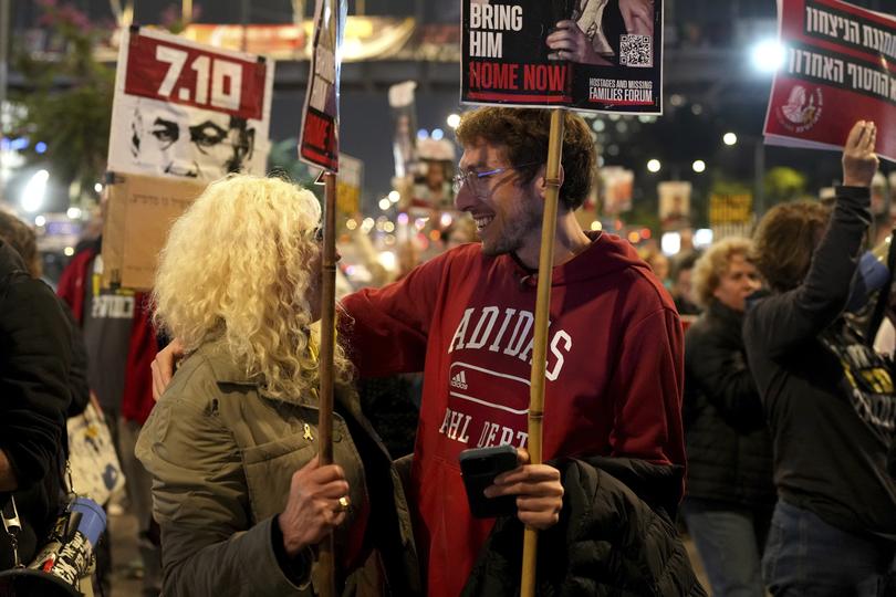 Relatives and friends of people killed and abducted by Hamas and taken into Gaza, react to the ceasefire announcement as they take part in a demonstration in Tel Aviv.