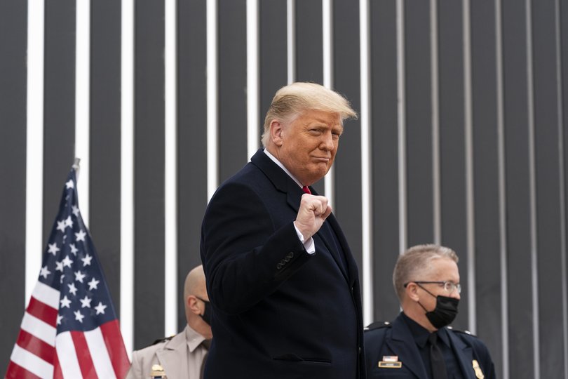 President Donald Trump pumps his fist as he tours a section of the US-Mexico border wall, in Alamo, Texas, 2021.