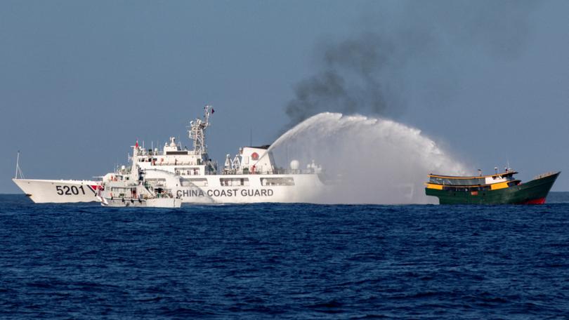 A Chinese coast guard vessel fires water cannons at a Philippine resupply vessel.