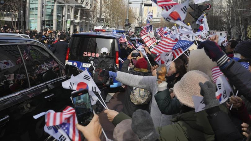 Supporters of impeached South Korean President Yoon Suk-yeol have swarmed his motorcade. 