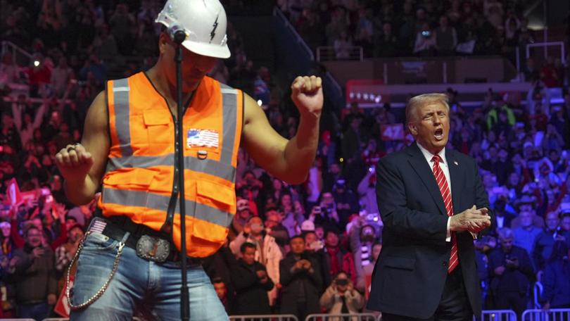 President-elect Donald Trump dances with Village People at a rally ahead of the 60th Presidential Inauguration, Sunday, Jan. 19, 2025, in Washington.