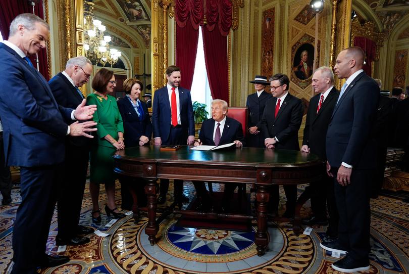 Newly sworn-in President Donald Trump (C) takes part in a signing ceremony in the President's Room following the 60th inaugural ceremony at the US Capitol in Washington, DC.