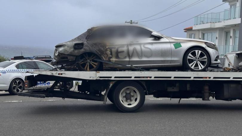 A house was sprayed with paint and two cars defaced and set alight in Sydney's east on Friday.