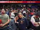 Supporters of President Donald Trump bow their heads during the invocation while watching inauguration ceremonies taking place at the U.S. Capitol on screens at Capitol One Arena in Washington, Monday, Jan. 20, 2025. (AP Photo/Mark Schiefelbein)