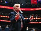 US President Donald Trump throws pens to the crowd after signing executive orders during the inaugural parade inside Capital One Arena.