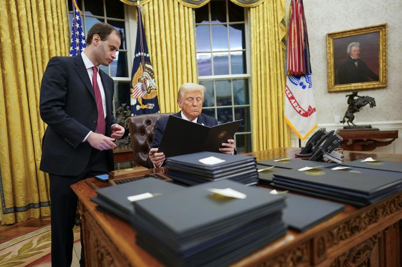 President Donald Trump signs executive orders at the White House.