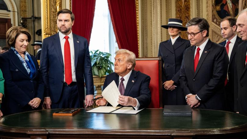 President Donald Trump signs executive orders at the White House on Monday. 