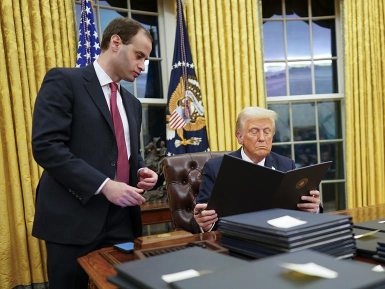 President Donald Trump signs executive orders at the White House.