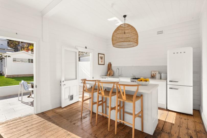 The modest kitchen has been freshly painted and leads straight to the garden.