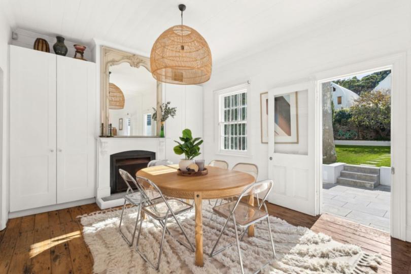 The dining room features an original fireplace and plenty of cupboard space.