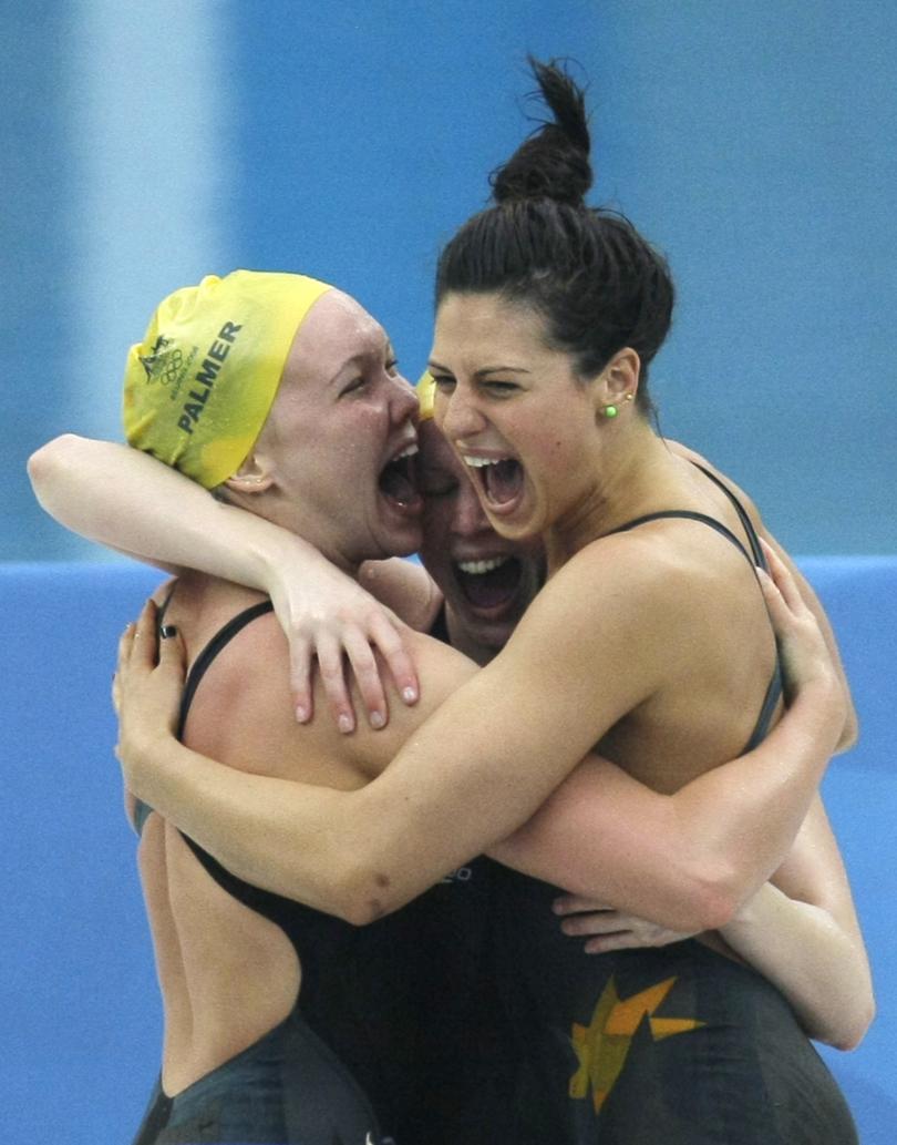 Australia's Kylie Palmer, Bronte Barratt and Stephanie Rice, from left, celebrate  setting a new world record and winning the gold in the women's 4x200-meter freestyle relay final during the swimming competitions in the National Aquatics Center at the Beijing 2008 Olympics in Beijing, Thursday, Aug. 14, 2008. (AP Photo/Anja Niedringhaus)