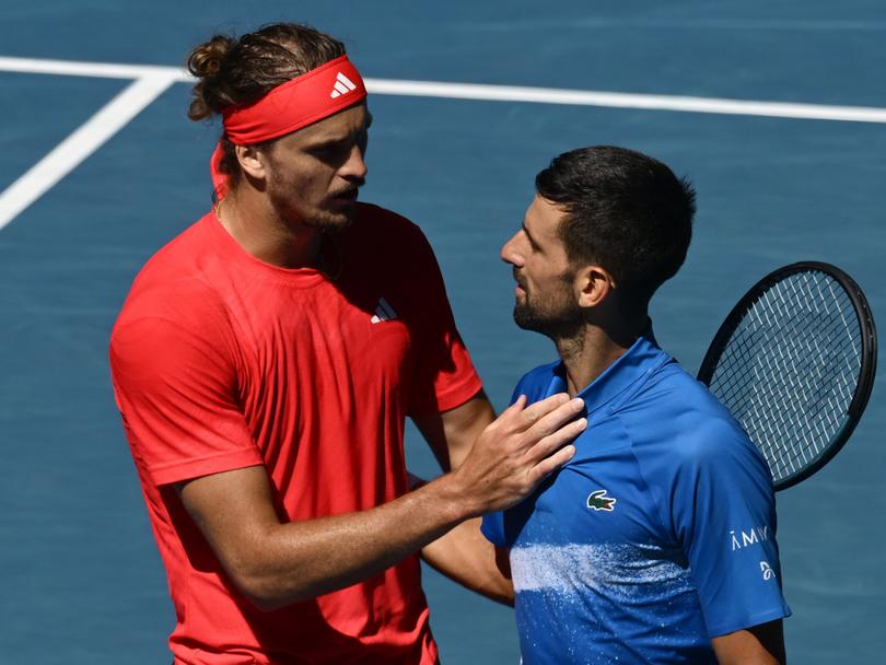 Novak Djokovic is embraced by Alexander Zverev after retiring hurt.