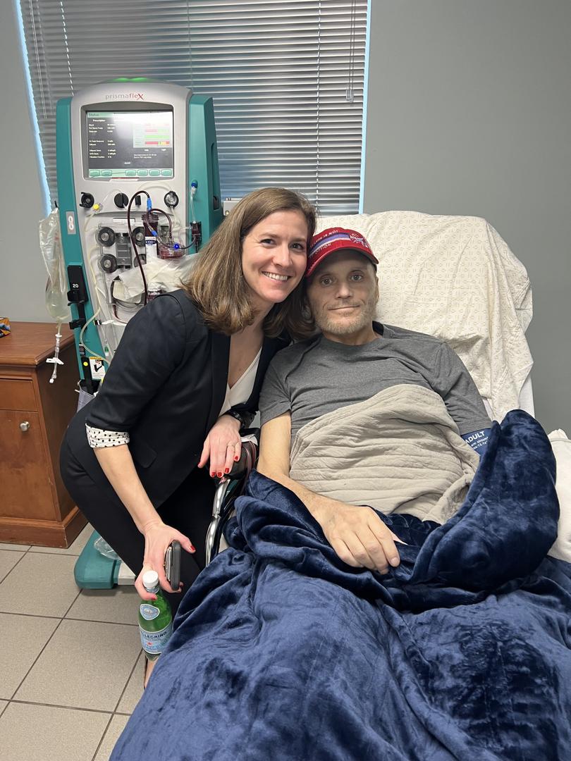 In an image provided by his wife, David Hudlow, stricken with esophageal cancer, in Antigua with Devon Quasha, an executive with Quadrant Clinical Care. 