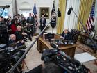 President Donald Trump speaks with reporters and signs executive orders in the Oval Office on Thursday.