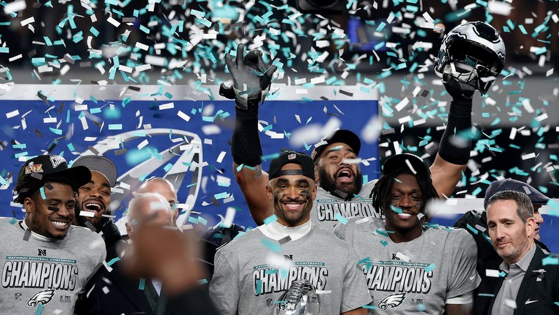 Jalen Hurts and his Eagles teammates celebrate their NFC Championship win.