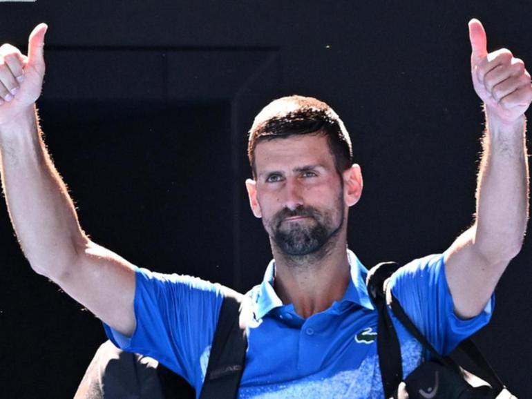 Novak Djokovic giving the thumbs-up to those jeering him after his Australian Open retirement. (James Ross/AAP PHOTOS)