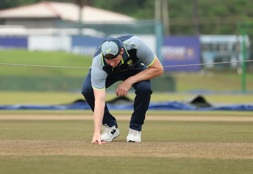 Steve Smith of Australia inspects the pitch.