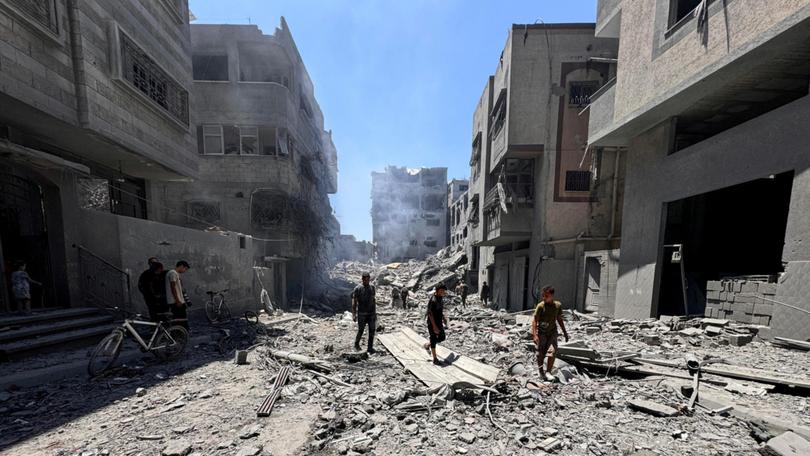 Palestinians search for casualties at the site of Israeli strikes on houses, amid Israel-Hamas conflict, at Al Shati refugee camp in Gaza City, June 22, 2024. 