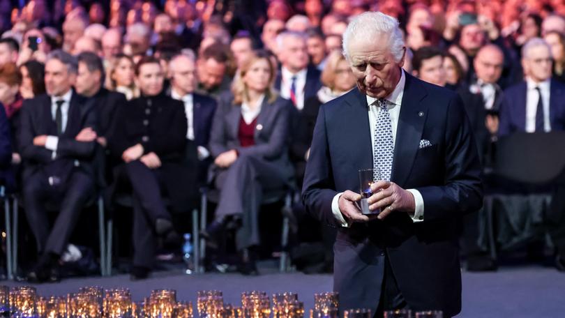 King Charles leaves candles by a symbolic nazi transport wagon in the Auschwitz - Birkenau Museum at the former Nazi German Auschwitz Concentration camp.