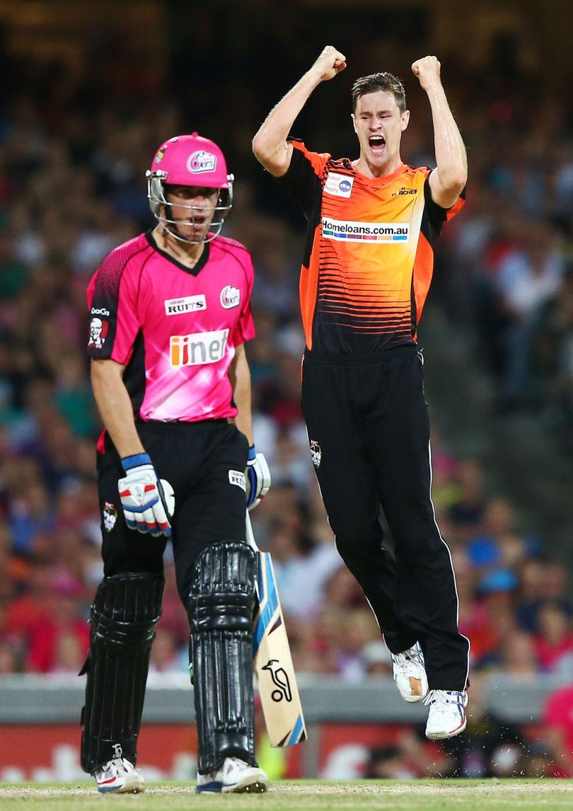 Jason Behrendorff celebrates taking the wicket of Moises Henriques in 2014.