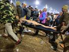 A deceased attendee is carried away after a stampede before the 'Amrit Snan' at the Kumbh Mela on January 29, 2025 in Allahabad, India. 