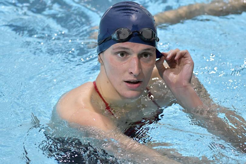 Transgender swimmer Lia Thomas speaks to her coach after winning the 500 metre freestyle during a meet with Harvard on Jan. 22, 2022.