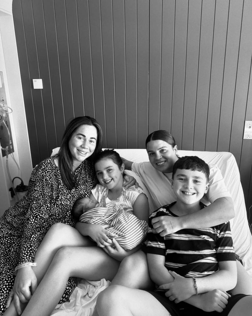 Sophie Cachia and her three children alongside partner Maddy Prespakis.