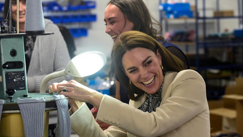 Catherine, Princess of Wales spends time with members of the production team on the factory floor during a visit to Corgi, a family run textiles manufacturer focused on the production of socks and knitwear.