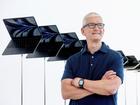 Apple CEO Tim Cook stands in front of a display of Apple MacBook Air computers. 