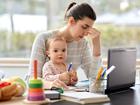 remote job, multi-tasking and family concept - tired mother with baby working at home office