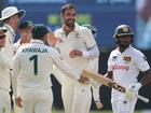 Mitchell Starc of Australia celebrates after taking the wicket of Kamindu Mendis.