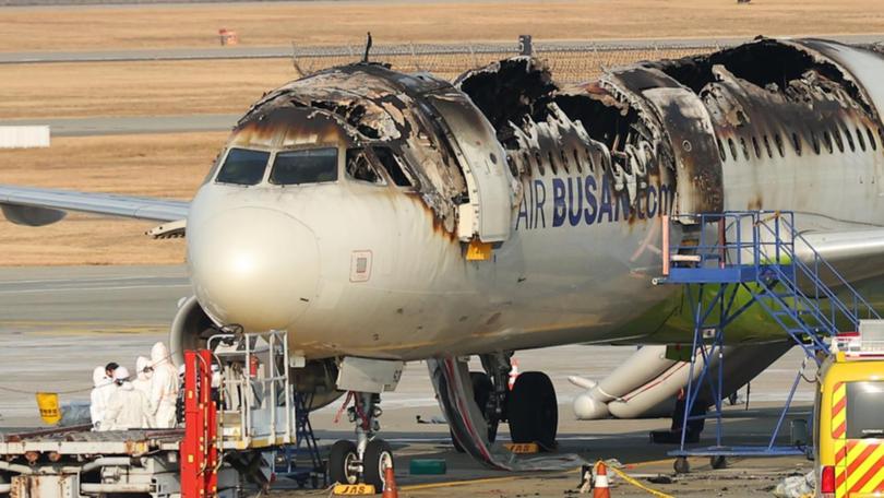 An investigation team conducts a stability inspection of a fire-damaged Air Busan plane. 