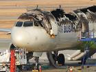 An investigation team conducts a stability inspection of a fire-damaged Air Busan plane. 