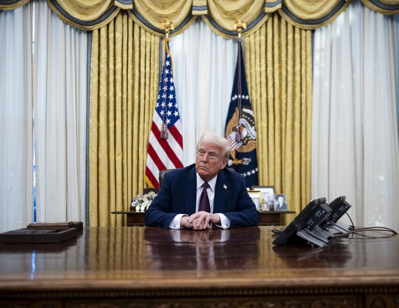 President Donald Trump talks to reporters after signing executive orders in the Oval Office of the White House in Washington, Jan. 23, 2025. 